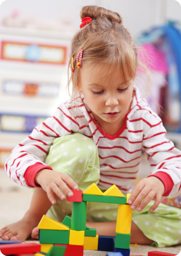 girl playing with bricks on the floor