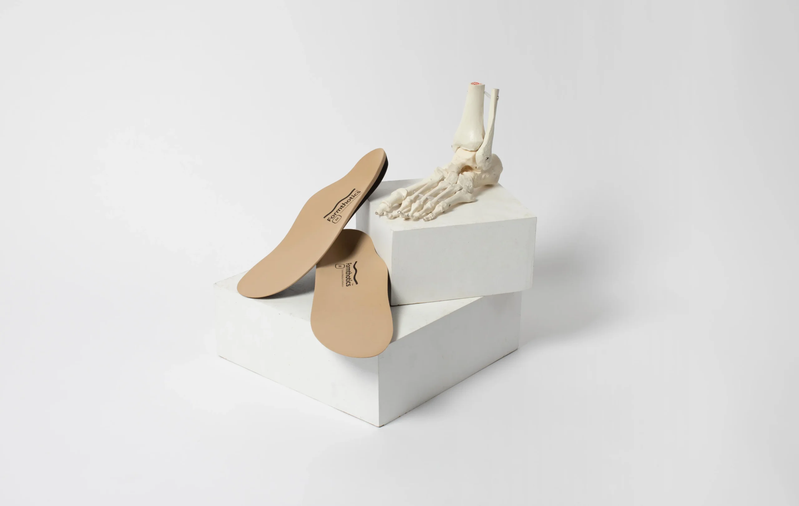 orthopedic soles on a box and skeleton foot
